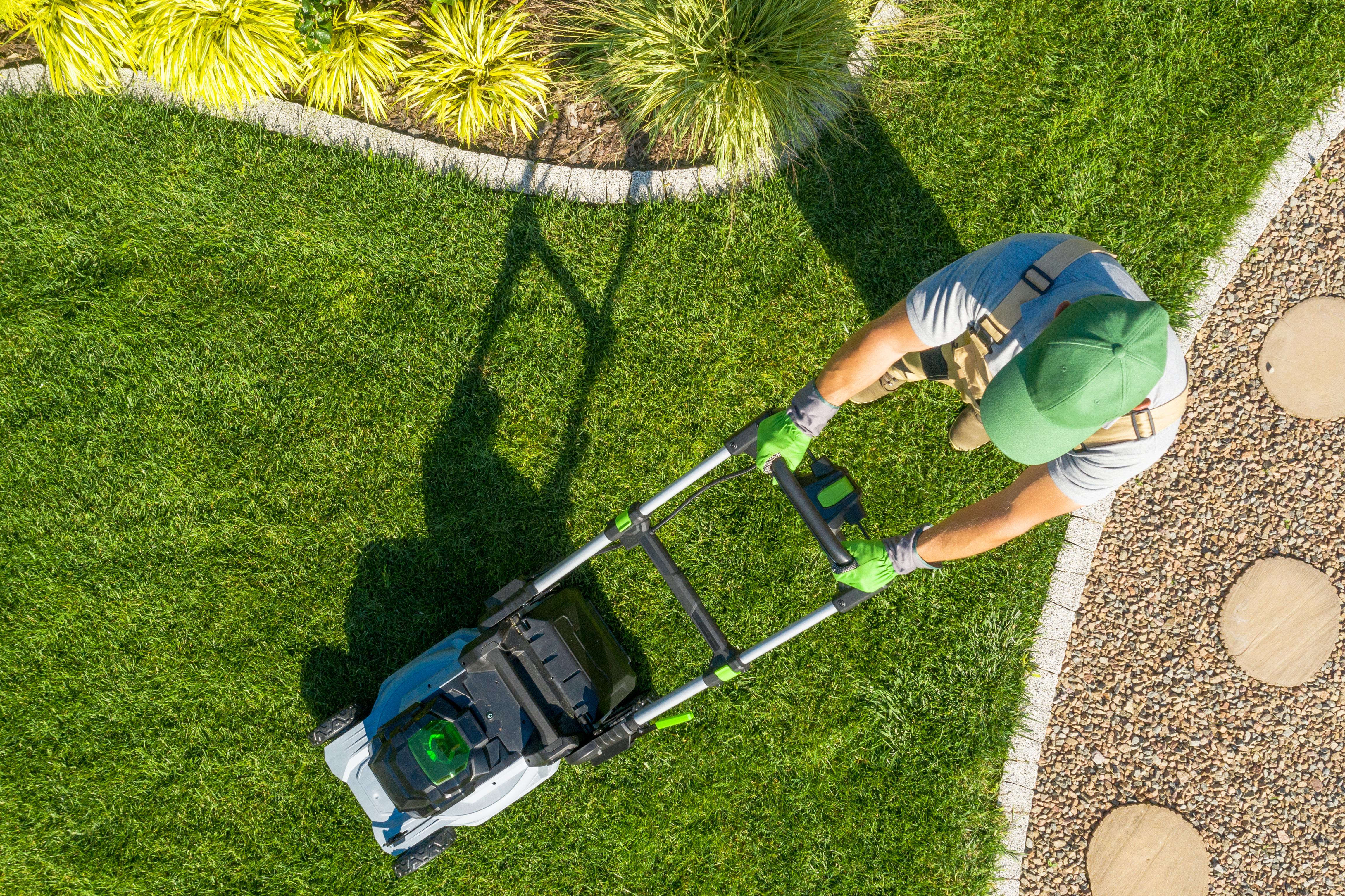 Landscaping professional mowing a lawn